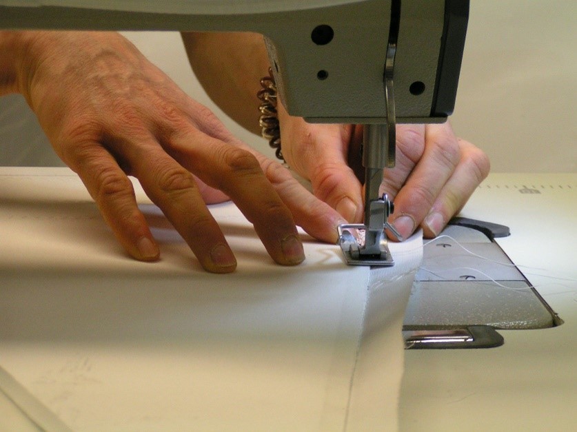 Hands using a sewing machine